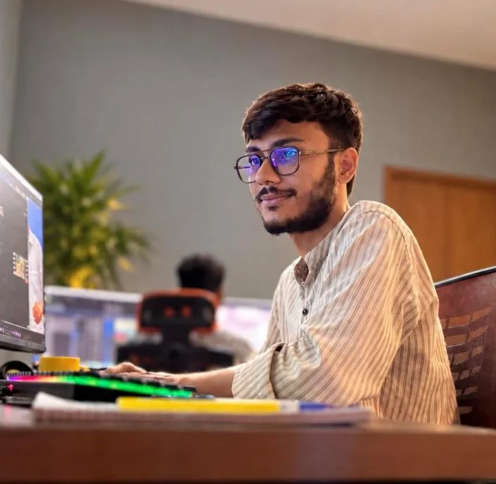 A 3D artist at his workstation in the studio