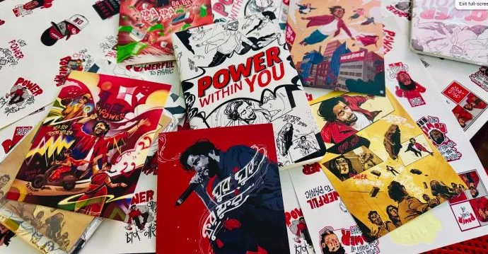 Power Within You comic art and posters spread on a table